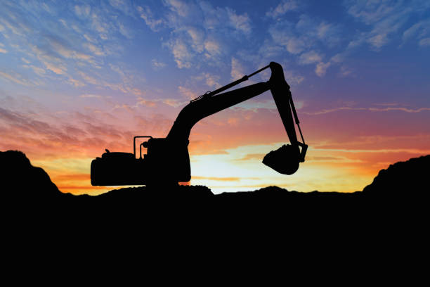 istock Crawler excavators silhouette are digging the soil in the construction site. 2186625816