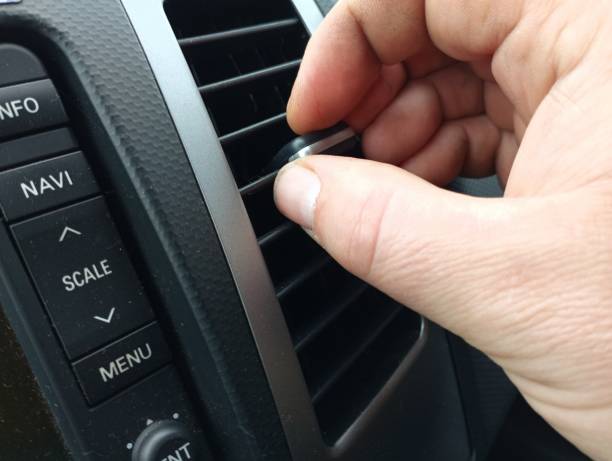 istock A person manually adjusts the air flow by adjusting the air duct flaps. 2186626077