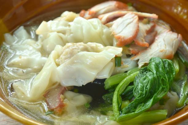 istock Chinese dumpling topping slice red barbecue pork with clear soup 2186626374