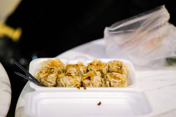 Filipino siomai in a take out container.