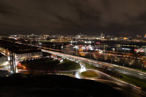 Gothenborg, Sweden – December 31, 2023: Colorful fireworks light up the night sky over Liseberg hill in Gothenburg, Sweden during New Year's Eve.
