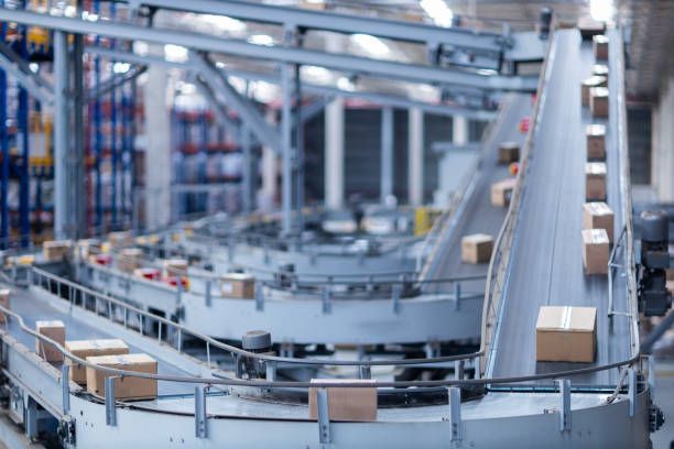 View of modern conveyor belts transporting boxes in a large warehouse ready for delivery. logistics.