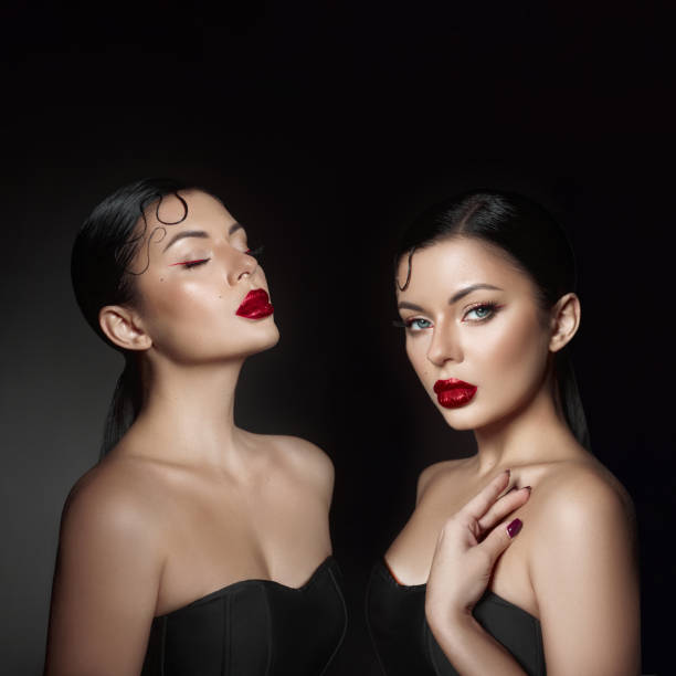 Models display stunning makeup artistry with glossy red lips and sleek hairstyles. contrasting background enhances their features, creating an elegant and dramatic effect.