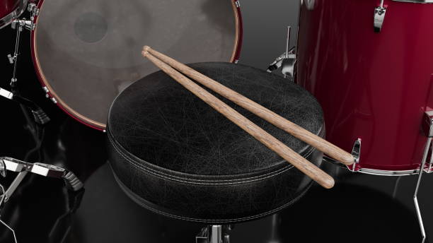 istock Wooden drumsticks rest on a black padded stool beside a red drum set, indicating preparation for a musical session or practice in a recording studio environment. 3d render 2186633109
