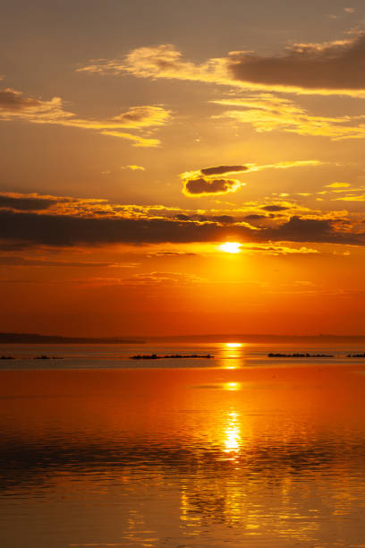 a sunset with the sun shining through clouds