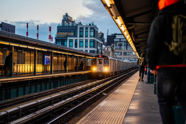 New York City, USA - December 7, 2023: Elevated subway train during sunset in Queens, New York City