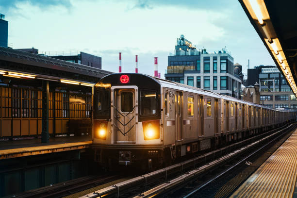 New York City, USA - December 7, 2023: Elevated subway train during sunset in Queens, New York City