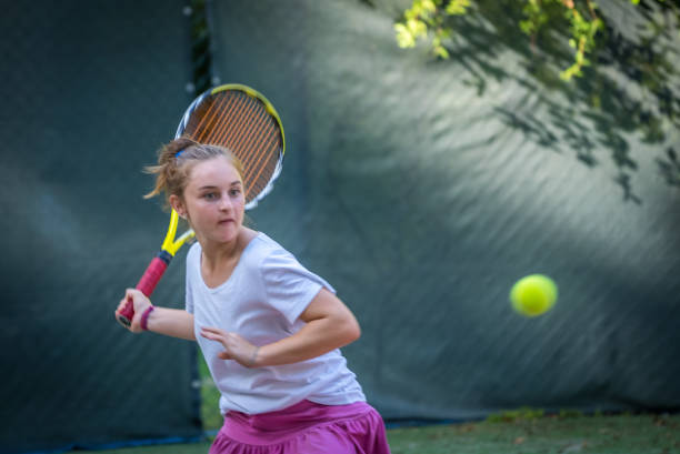 istock A girl playing tennis 2186638625