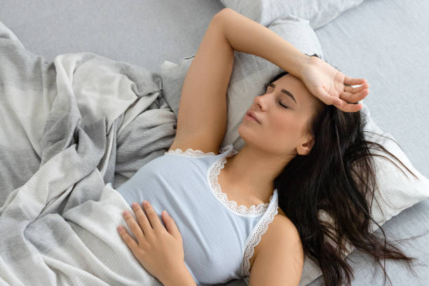 istock Woman sleeping in bed 2186639327