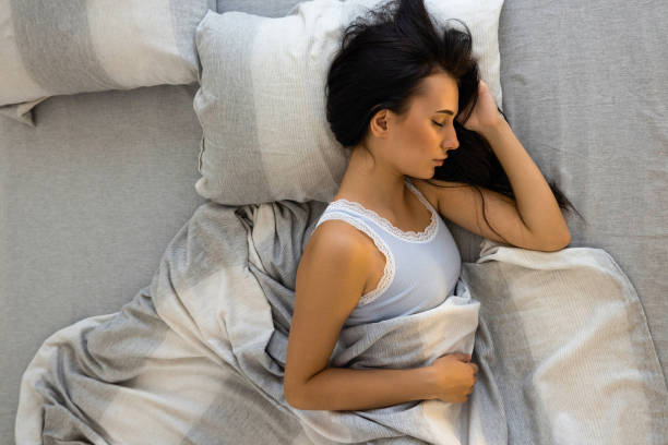 istock Woman sleeping in bed 2186639365