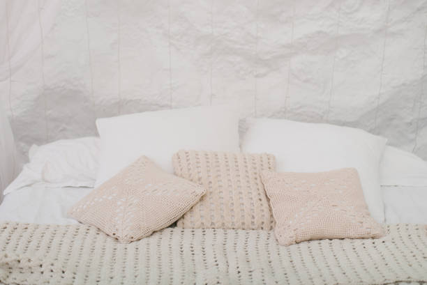 istock Cozy bed with white pillows and blanket 2186639983