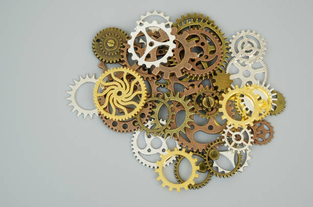 Heap of many different steampunk gears on gray background. Copy space for text.