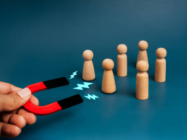 istock Business digital marketing, data network, attract leads and customers concept. Magnet inhand, attracts wooden figures as people, blue background. Business team building, recruitment, hiring concepts. 2186642150