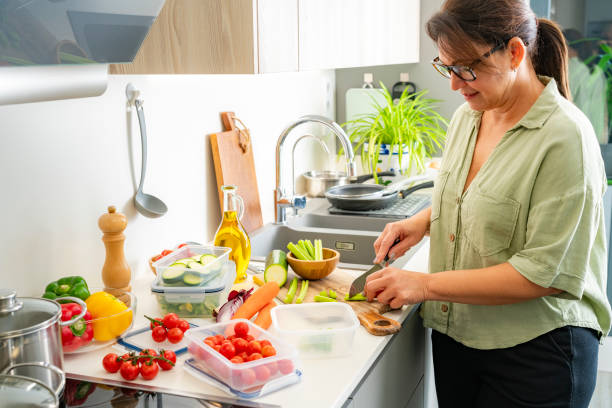 istock Woman preparing vegetables to be stored in plastic containers 2186643541