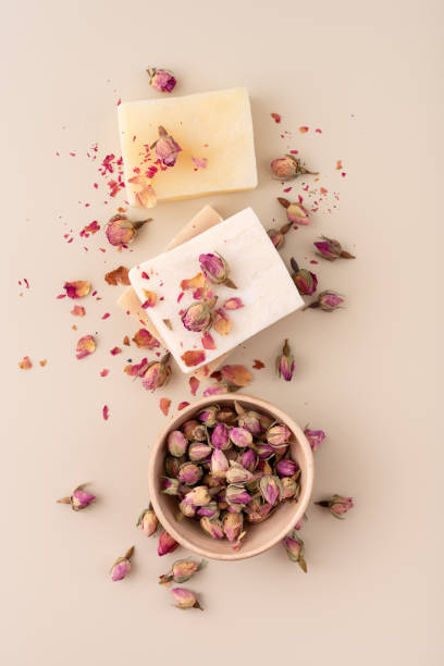 istock Handmade natural soap bars with dried rose petals on a beige background 2186644113