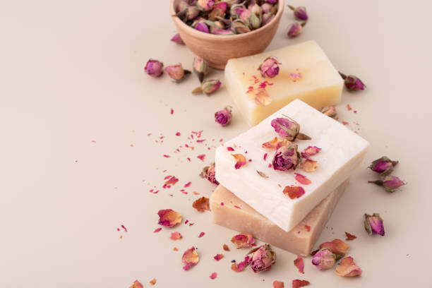 istock Handmade natural soap bars with dried rose petals on a beige background 2186644146