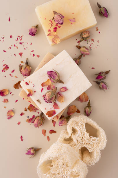 istock Handmade natural soap bars with dried rose petals on a beige background 2186644158