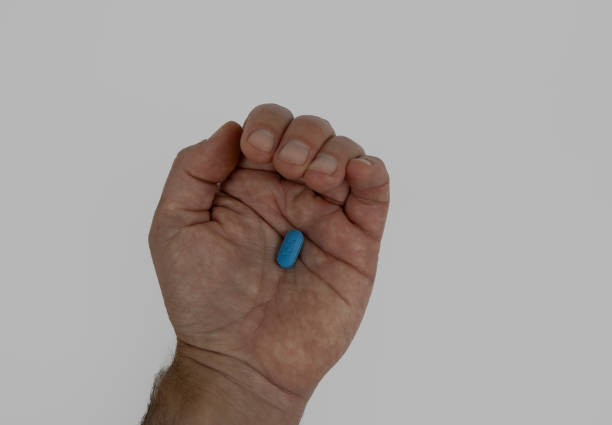 istock Blue pill in male hand 2186645537
