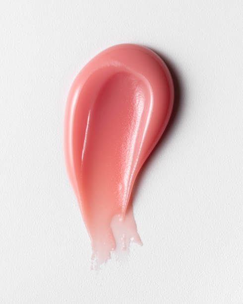Pink or light red lipgloss texture isolated on white background