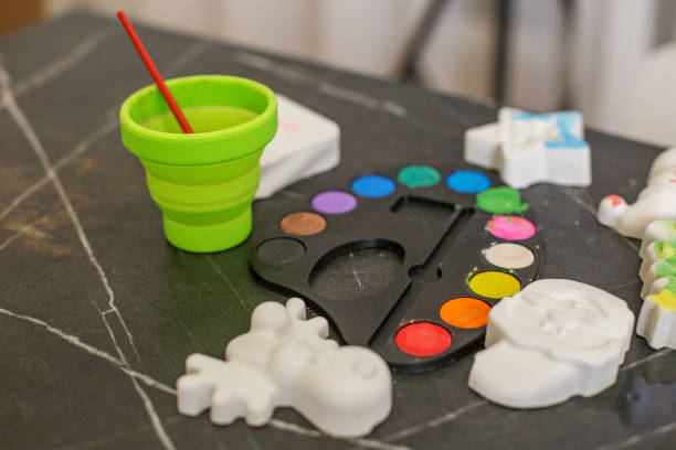istock Colorful paint palette and crafting materials arranged on table for creative activities 2186648882
