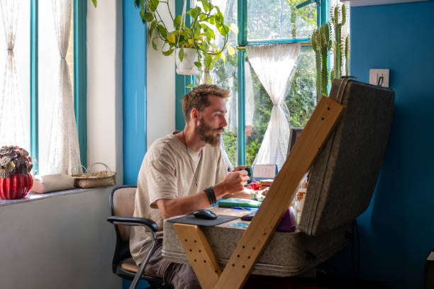 istock Young man working from home in cozy room with plants 2186649845