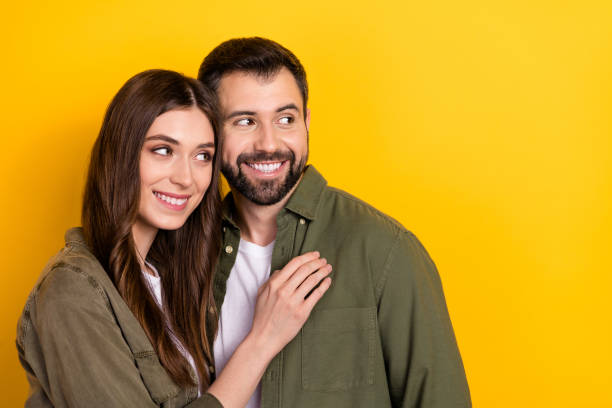 istock Portrait of attractive cheerful affectionate couple hugging copy space isolated over bright yellow color background 2186649946