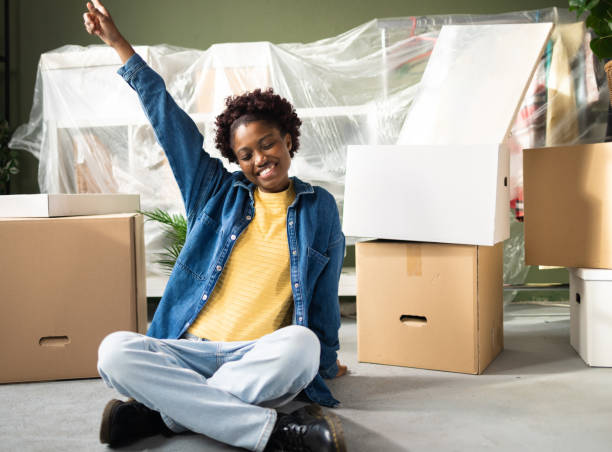 istock Cheerful black woman celebrating while setting up her new apartment 2186651098