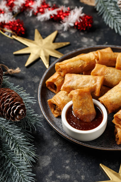 istock Christmas duck spring rolls with decoration, gifts, green tree branch 2186652259