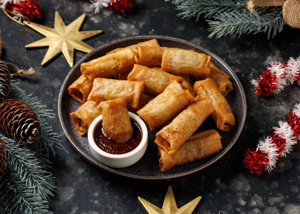 istock Christmas duck spring rolls with decoration, gifts, green tree branch 2186652285