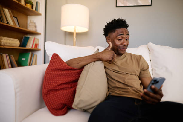 istock Smiling Man Engaging in a Video Call from Cozy Living Room 2186652466