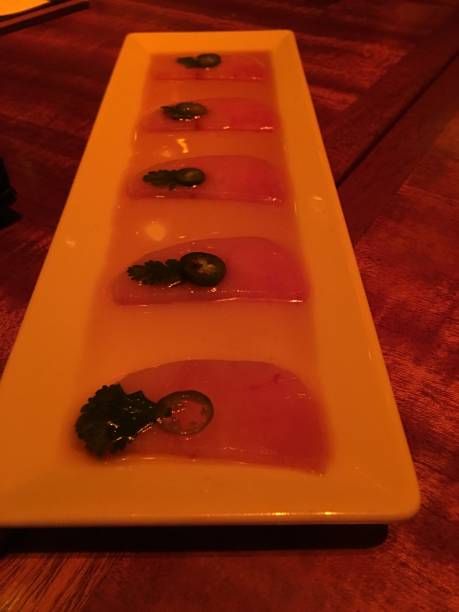 sushi sashimi plate with cilantro and jalapenos