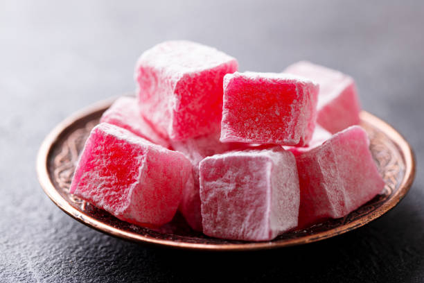 istock Turkish delight, rose flavour in a copper plate. Grey background. Close up. 2186655255