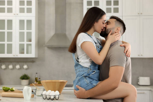istock Affectionate young couple kissing in kitchen. Space for text 2186656690