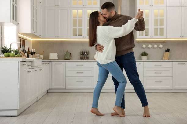 istock Affectionate young couple dancing and kissing in kitchen. Space for text 2186656759