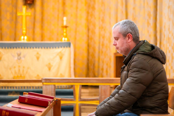 istock Man praying in Anglican church 2186657915