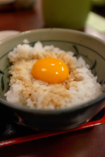 Raw egg yolk on a bowl of rice