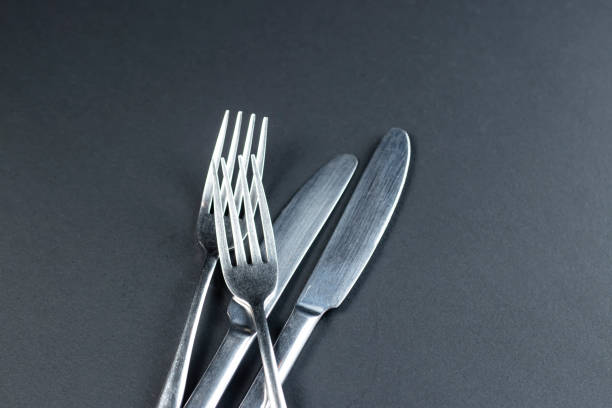 istock Sleek Silverware Set featuring a fork and knife isolated black background top view of kitchen utensils 2186662917