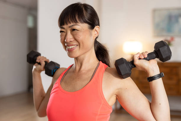 istock Determined woman doing sport training with weights to stay fit 2186663389