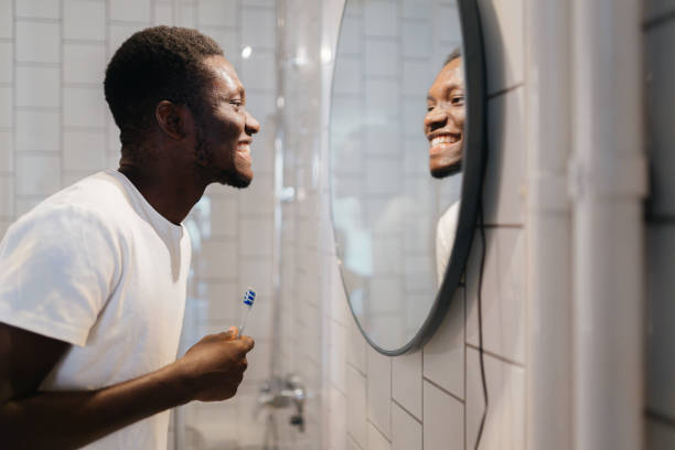 istock Young man brushing his teeth in the bathroom 2186663451