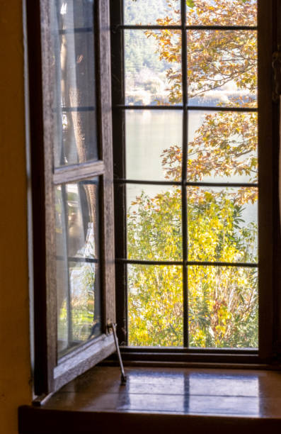 istock The old window with the autumn lake view 2186663764