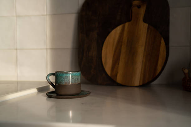 istock One cup of coffee on a marble worktop in a kitchen with sunset light. Aesthetic minimal concept. 2186664486
