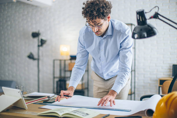 istock Engineer man working in the office, drawing and planning the construction project. 2186666207
