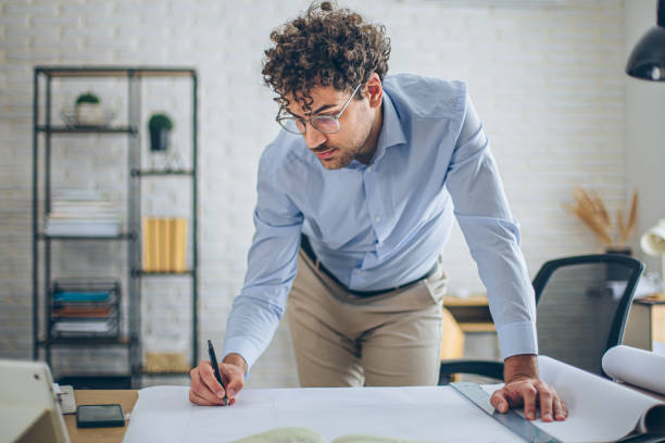 istock Engineer man working in the office, drawing and planning the construction project. 2186666544