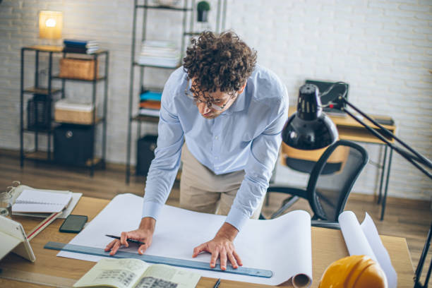 istock Engineer man working in the office, drawing and planning the construction project. 2186666821