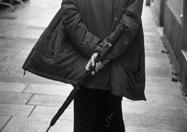 istock MAN HOLDING UMBRELLA ON HIS BACK 2186671556