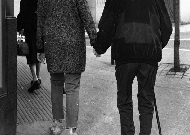 istock PEOPLE HOLDING HANDS WALKING ON THE STREET 2186671571