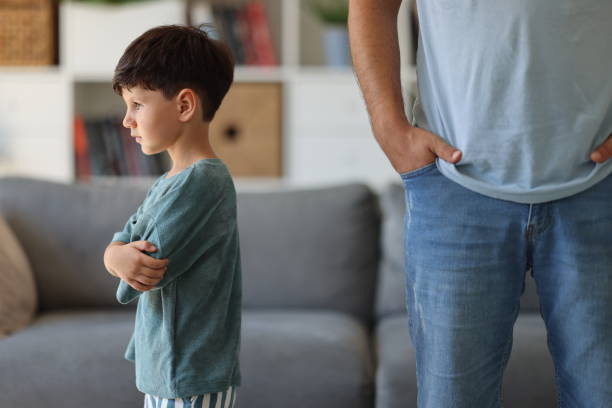 istock Annoyed father back to back with son ignoring each other after argue 2186673758