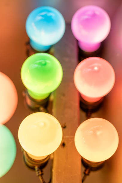 A vibrant close-up of glowing multicolored light bulbs arranged in a playful pattern. The soft gradient hues of green, yellow, pink, and blue create a cheerful and eye-catching composition.