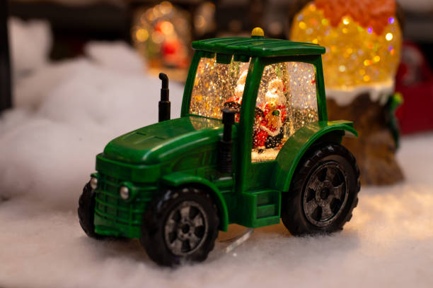 istock Festive Green Tractor with Santa Snow Globe 2186678044