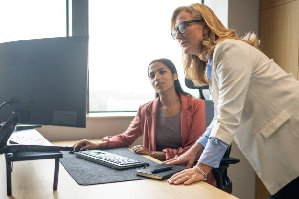 istock Senior executive mentoring younger colleague in an office 2186678770